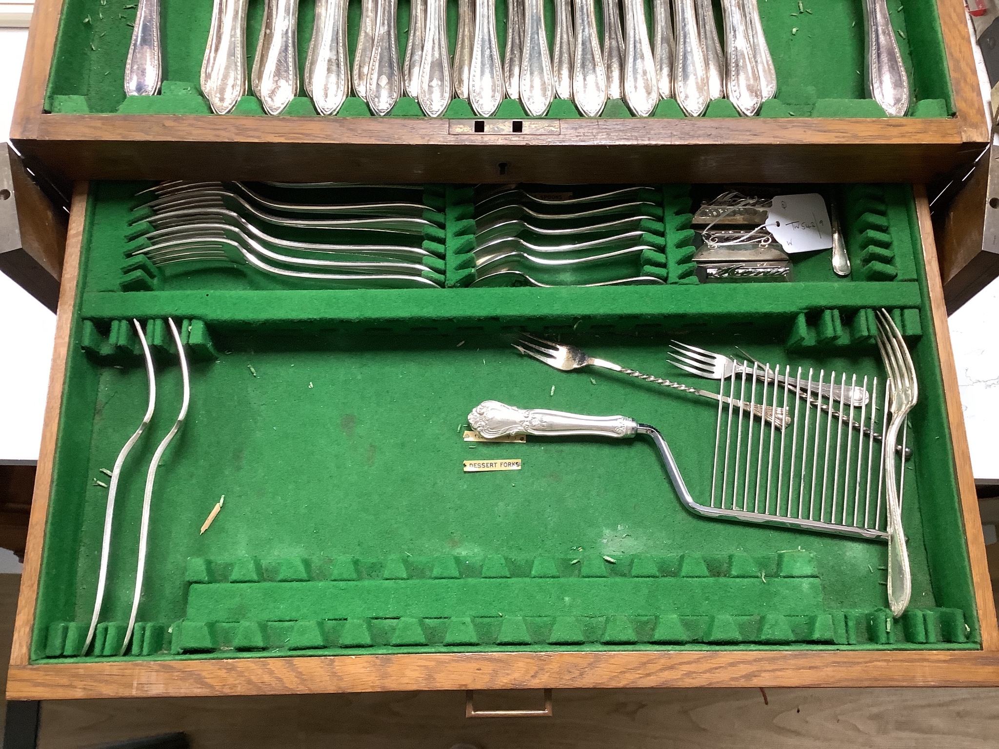 A set of three silver menu holders and a part service of Community Plate, in 1930's oak table canteen